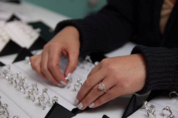 A customer trying on our moissanite engagement rings.