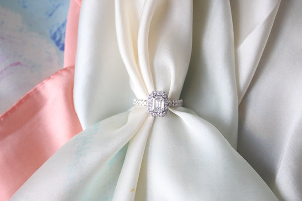 Stunning Silver Emerald Cut ring held by silk scarf